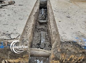 Hydro vacuum excavation truck exposing underground pipes safely.